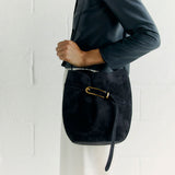 BELTED BUCKET CROSSBODY BAG